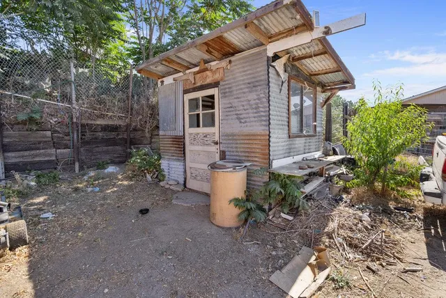 a view of a backyard with plants and a patio