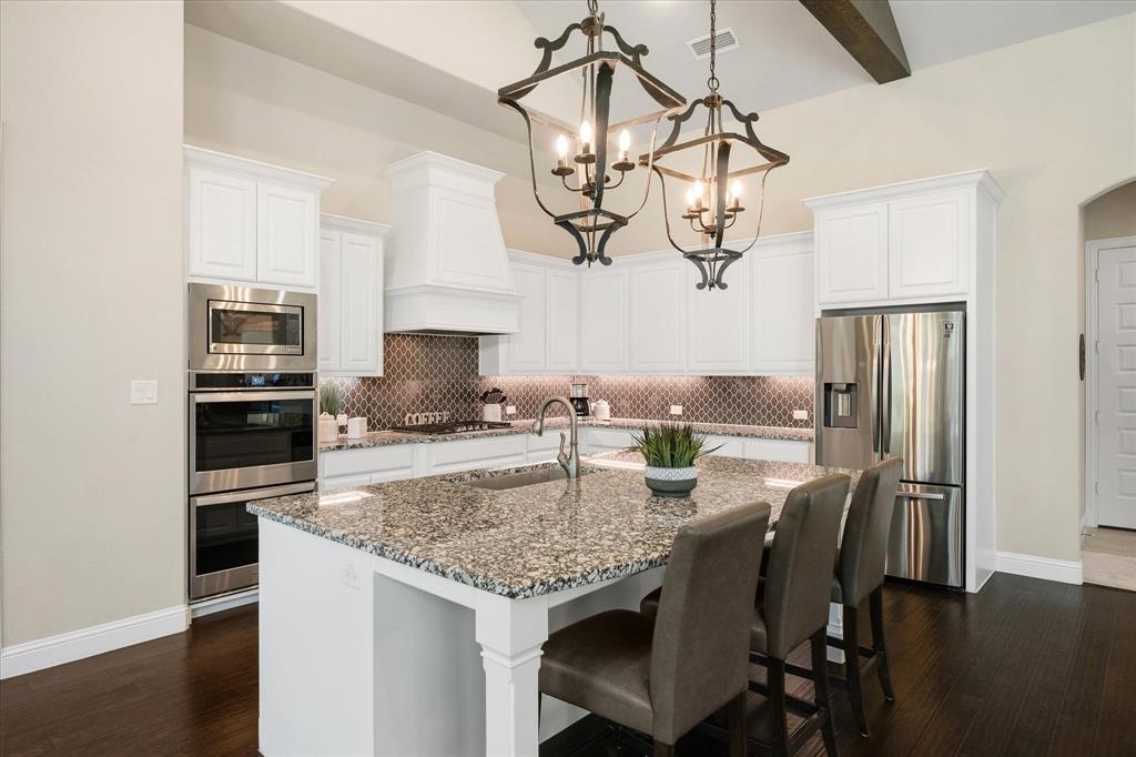406 Prairie View Road Rockwall, TX 75087 - Photo 14 of 38 Center island is the heart of the kitchen and is perfect for family meals or entertaining.