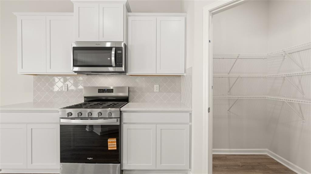 2242 Edgecombe Lane Dacula, GA 30019 - Photo 11 of 33 a kitchen with a stove and a microwave