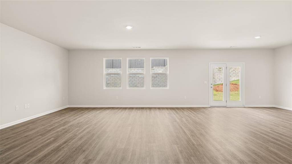 2242 Edgecombe Lane Dacula, GA 30019 - Photo 14 of 33 a view of an empty room with wooden floor and a window