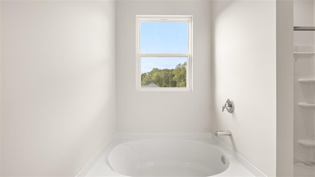 2242 Edgecombe Lane Dacula, GA 30019 - Photo 25 of 33 a bathroom with a tub