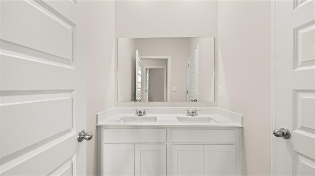 2242 Edgecombe Lane Dacula, GA 30019 - Photo 32 of 33 a bathroom with a sink and a mirror
