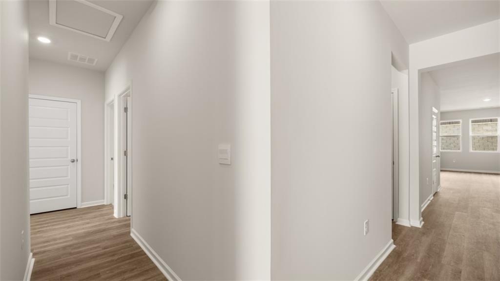 2242 Edgecombe Lane Dacula, GA 30019 - Photo 4 of 33 a view of a hallway with wooden floor and a bathroom