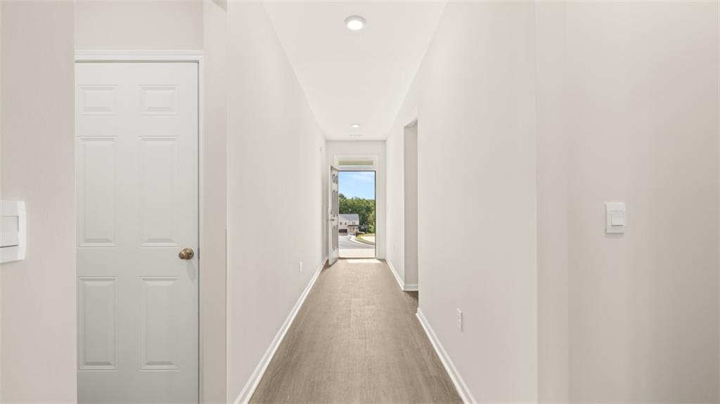 2242 Edgecombe Lane Dacula, GA 30019 - Photo 5 of 33 a view of a hallway with wooden floor