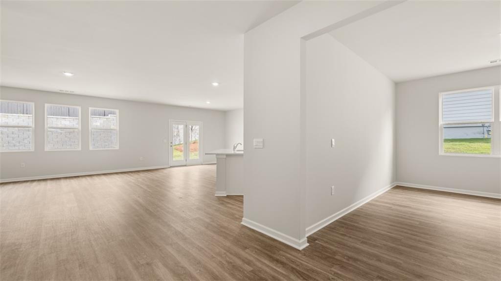 2242 Edgecombe Lane Dacula, GA 30019 - Photo 6 of 33 a view of empty room with wooden floor and fan