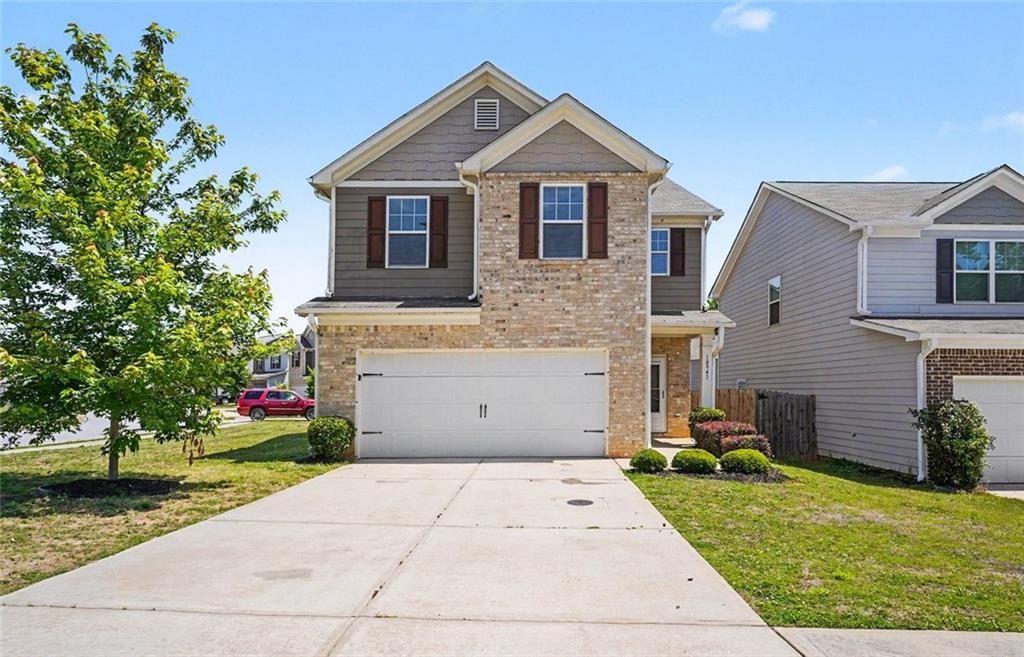 10941 Wheeler Trace Hampton, GA 30228 - Photo 1 of 21 a front view of a house with a yard