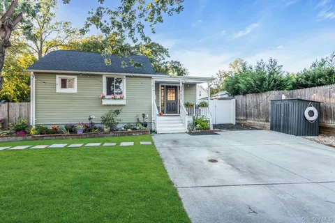 a front view of house with yard and outdoor seating