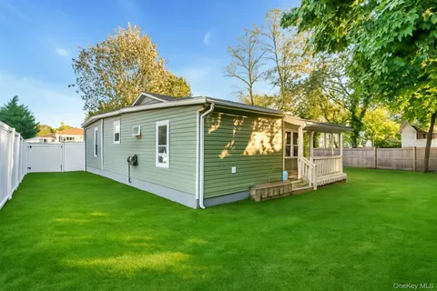 a view of a house with a yard and sitting area