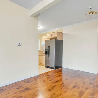 a kitchen with stainless steel appliances granite countertop a sink and cabinets with wooden floor