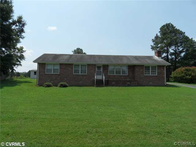 25419 Front Road Petersburg, VA 23803 - Photo 1 of 4 a front view of a house with a garden