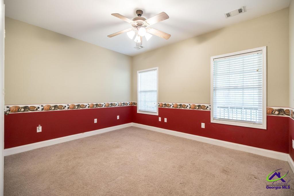 204 Smith Road Haddock, GA 31033 - Photo 29 of 51 an empty room with windows and ceiling fan