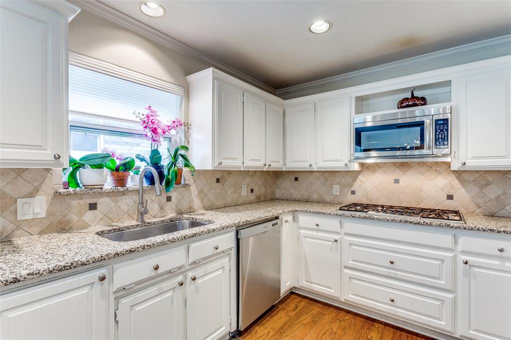 2229 Weatherbee Street Fort Worth, TX 76110 - Photo 11 of 25 Kitchen with a sink, white cabinetry, and appliances with stainless steel finishes