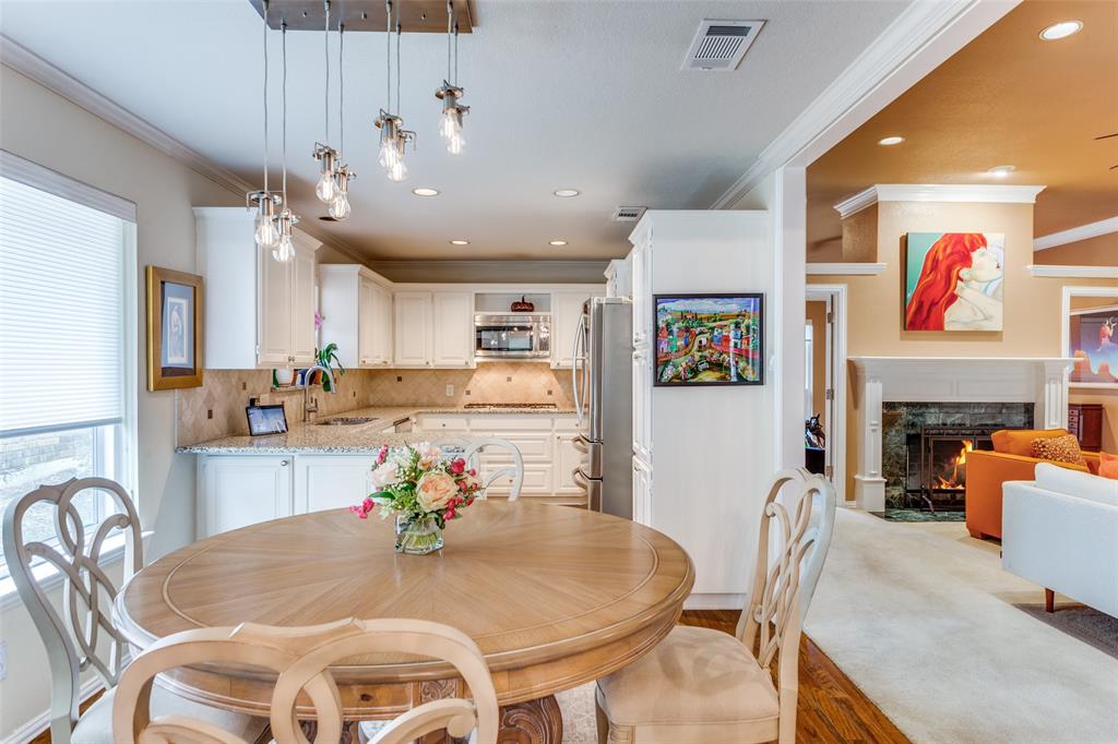 2229 Weatherbee Street Fort Worth, TX 76110 - Photo 12 of 25 Dining area with crown molding, a healthy amount of sunlight, and visible vents