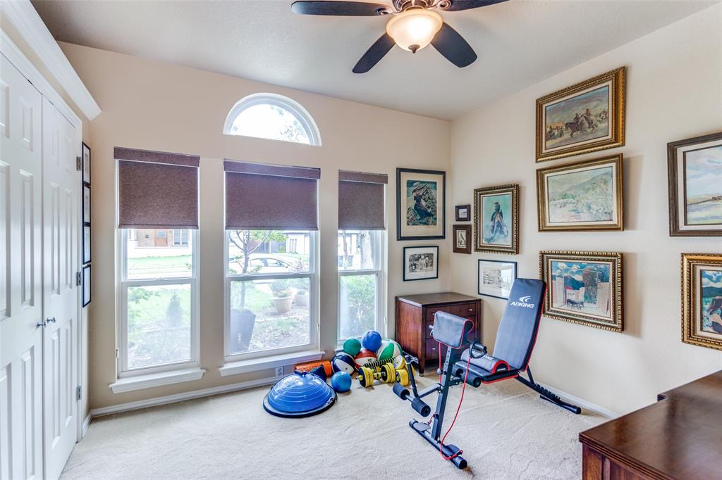 2229 Weatherbee Street Fort Worth, TX 76110 - Photo 13 of 25 Exercise area with baseboards, ceiling fan, and carpet
