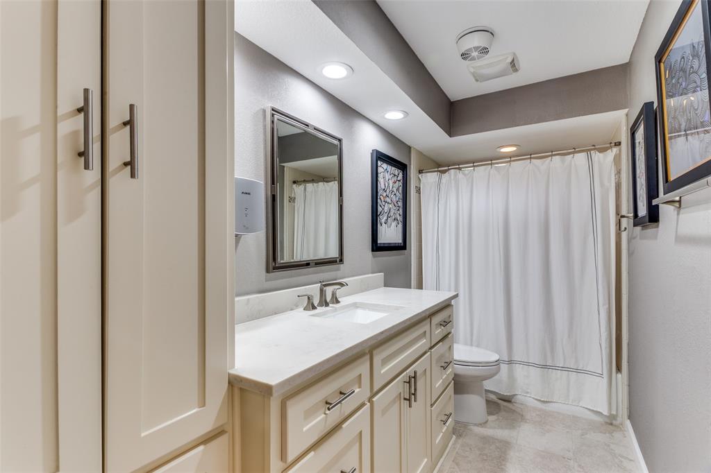 2229 Weatherbee Street Fort Worth, TX 76110 - Photo 14 of 25 Bathroom featuring vanity, toilet, recessed lighting, baseboards, and curtained shower