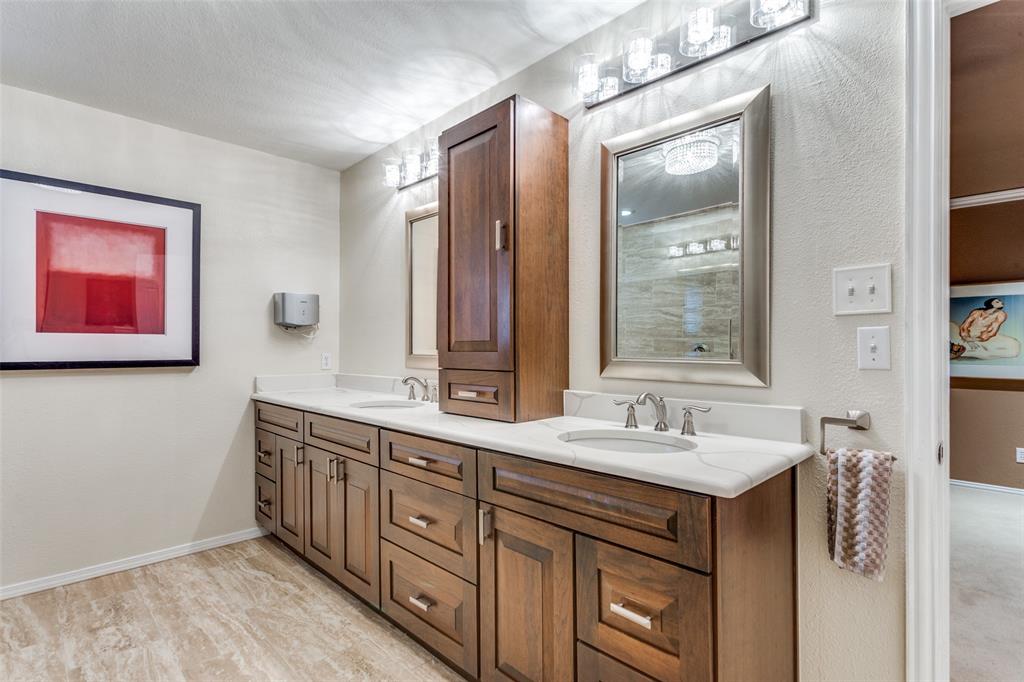 2229 Weatherbee Street Fort Worth, TX 76110 - Photo 19 of 25 Bathroom featuring a sink, baseboards, and double vanity