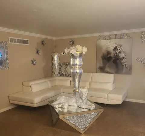 a living room with furniture and a chandelier