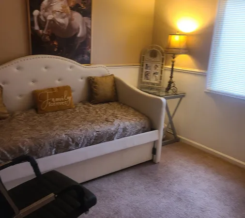 a bedroom with a bed and a window