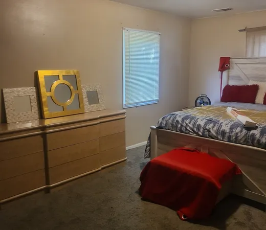 a bedroom with a bed and a window
