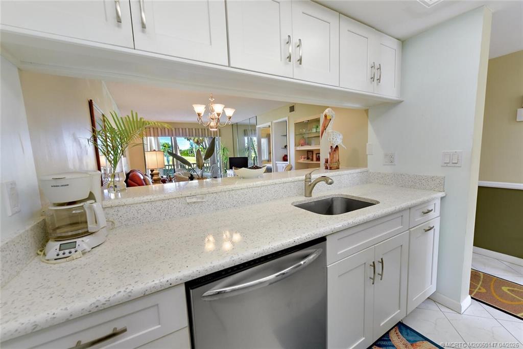5811 Northeast Gulfstream Way, Unit 4002 Stuart, FL 34996 - Photo 11 of 39 a kitchen with stainless steel appliances granite countertop a sink and cabinets