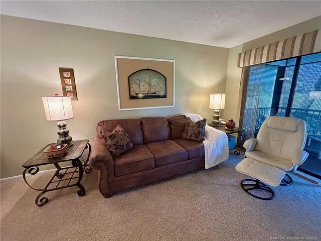 a living room with furniture and a dining room