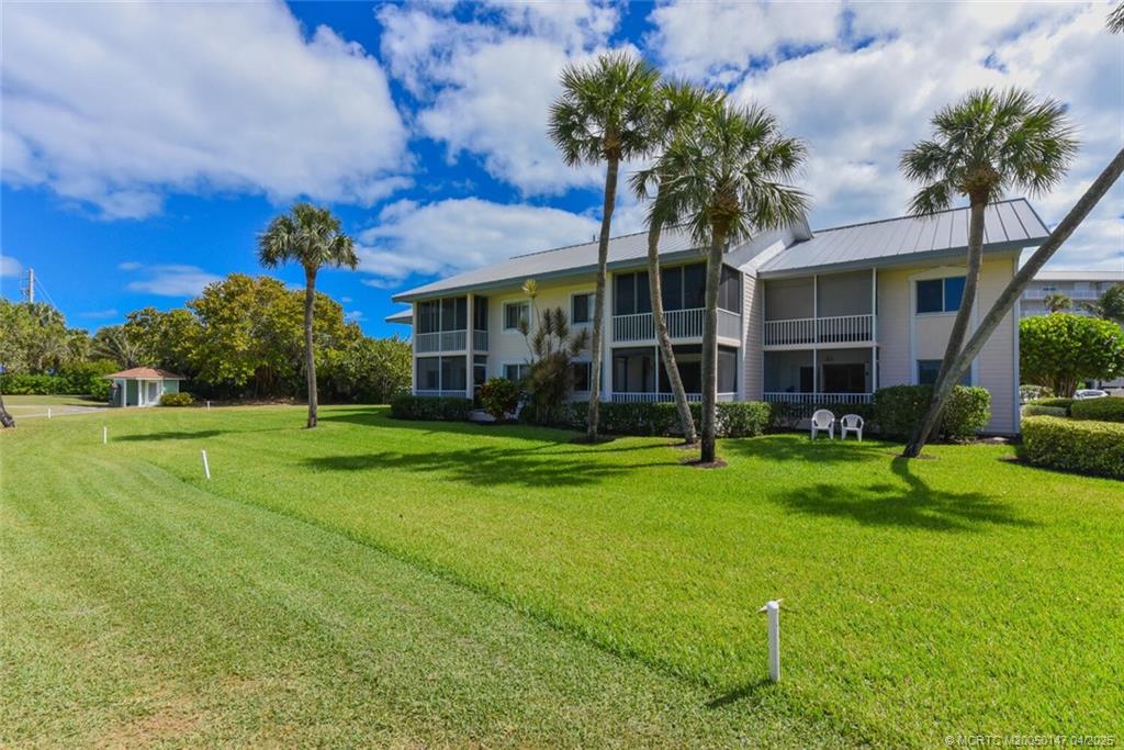 5811 Northeast Gulfstream Way, Unit 4002 Stuart, FL 34996 - Photo 26 of 39 a front view of house with yard and green space
