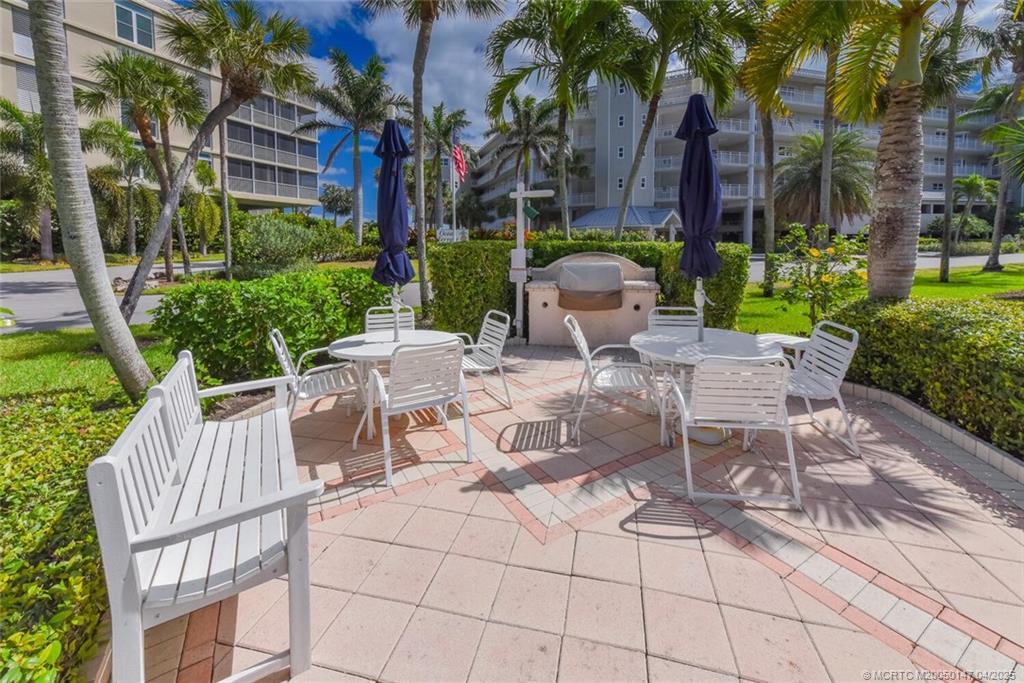 5811 Northeast Gulfstream Way, Unit 4002 Stuart, FL 34996 - Photo 28 of 39 a view of a chairs and tables in the patio