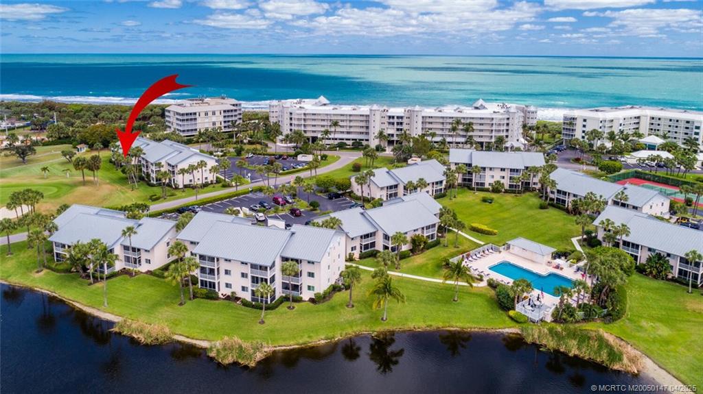 5811 Northeast Gulfstream Way, Unit 4002 Stuart, FL 34996 - Photo 34 of 39 an aerial view of a house with a garden and lake view