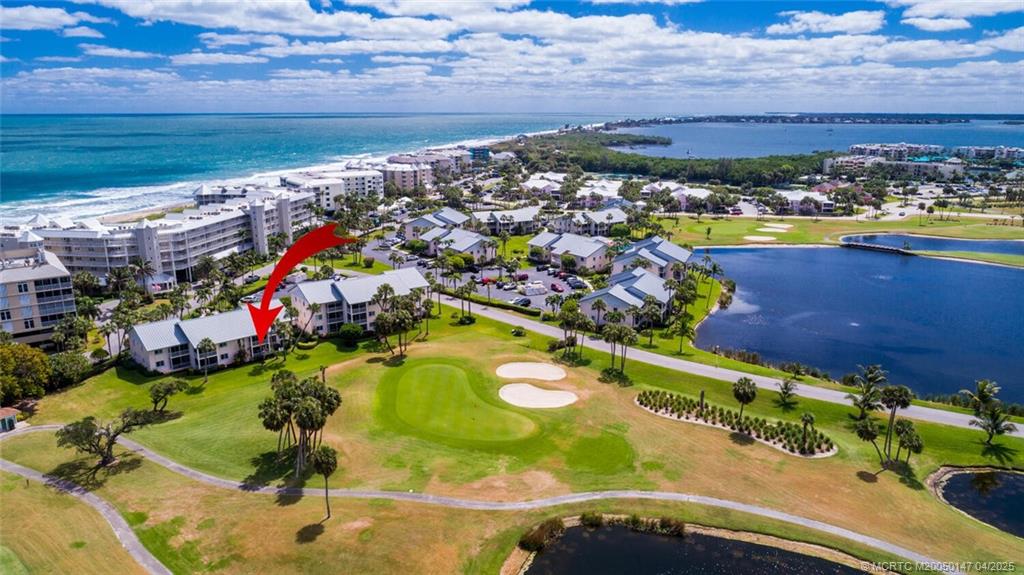 5811 Northeast Gulfstream Way, Unit 4002 Stuart, FL 34996 - Photo 35 of 39 a view of a swimming pool with a lot of plants in front of house