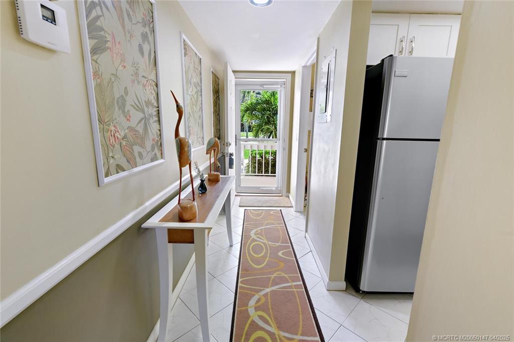 5811 Northeast Gulfstream Way, Unit 4002 Stuart, FL 34996 - Photo 7 of 39 a hallway with furniture and a window
