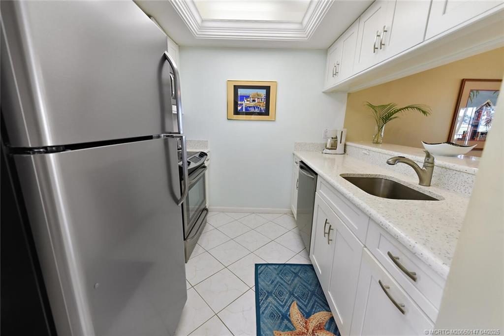 5811 Northeast Gulfstream Way, Unit 4002 Stuart, FL 34996 - Photo 8 of 39 a bathroom with a sink and mirror
