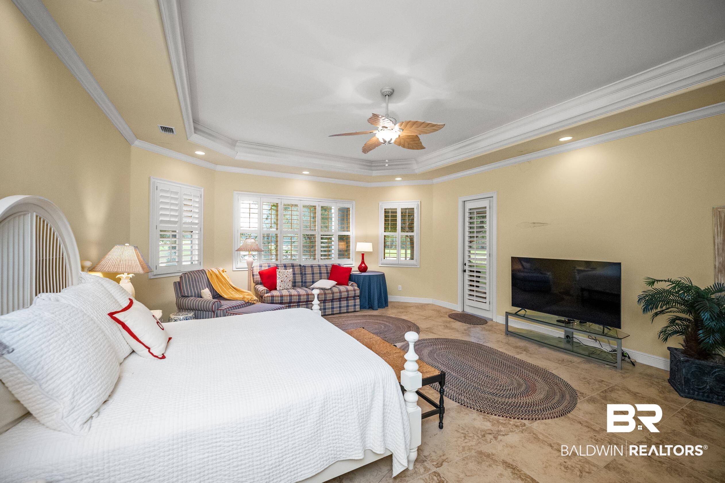 404 Peninsula Boulevard Gulf Shores, AL 36542 - Photo 25 of 51 Bedroom featuring a raised ceiling, access to exterior, recessed lighting, ornamental molding, and a ceiling fan
