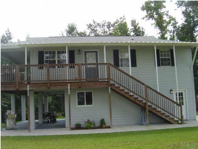 6510 River Bend Road Molino, FL 32577 - Photo 9 of 24 Like what you see so far? Let`s go in the downstairs area first. You have a single car garage with auto door opener, a side door at the stairs, and double doors going out to the covered patio.