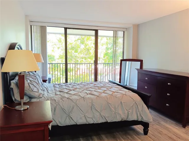 a bedroom with a bed a lamp and a window