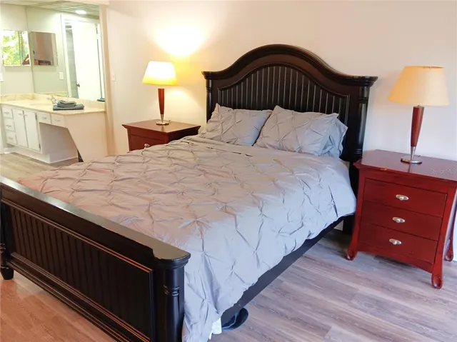 a bedroom with a bed and a night stand