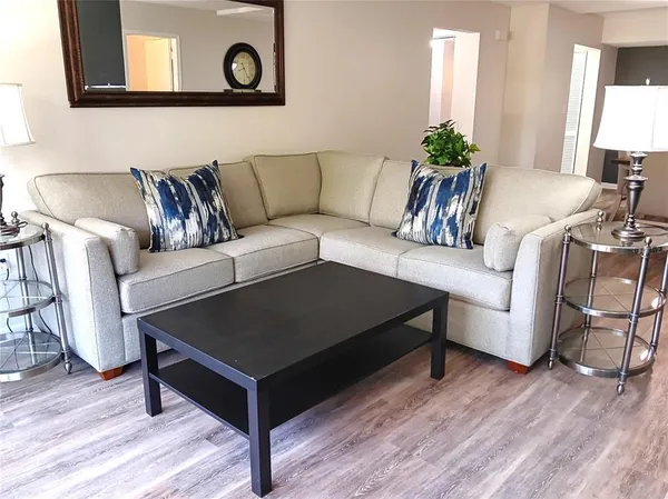 a living room with furniture and a potted plant