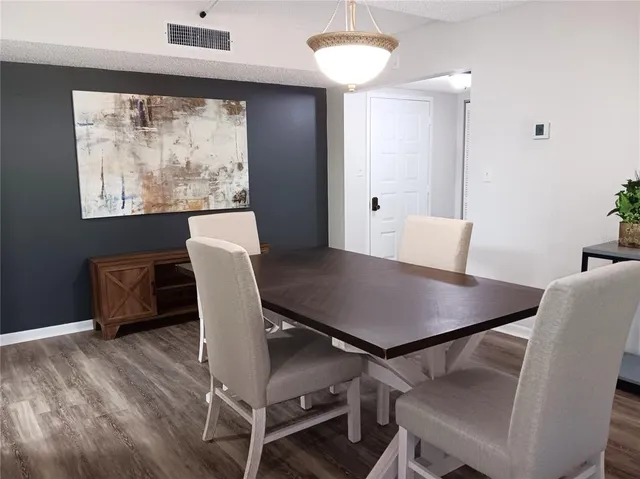 a view of a dining room with furniture and a large window