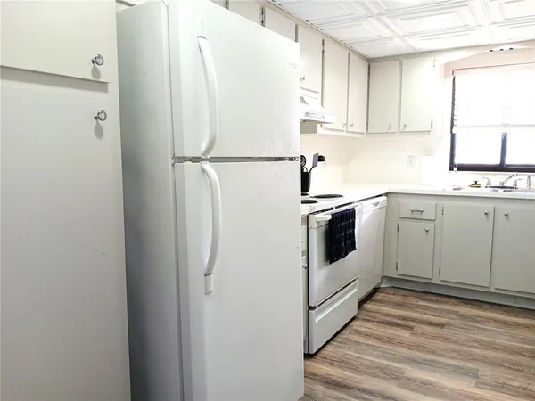 a white refrigerator freezer sitting inside of a kitchen