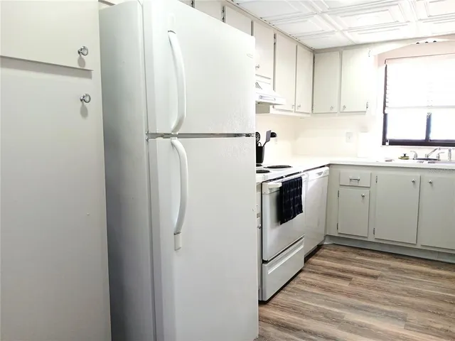a white refrigerator freezer sitting inside of a kitchen