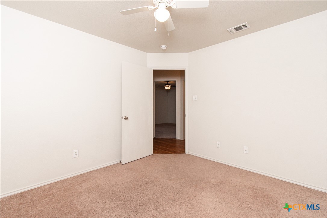 6509 Temora Loop, Unit A Killeen, TX 76549 - Photo 10 of 19 a view of an empty room with a chandelier fan