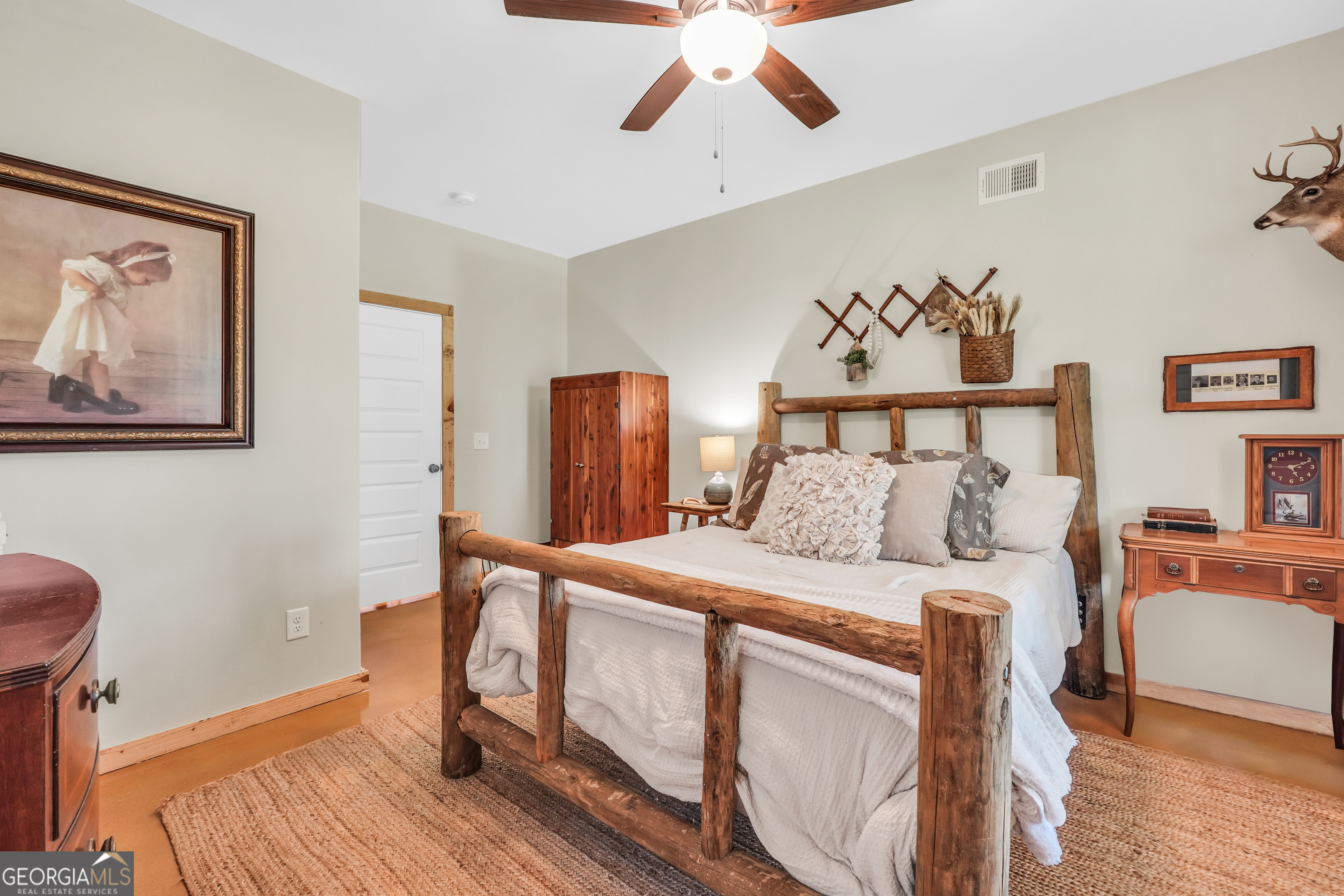 239 Walters Road Barnesville, GA 30204 - Photo 31 of 81 a bedroom with a bed and wooden floor