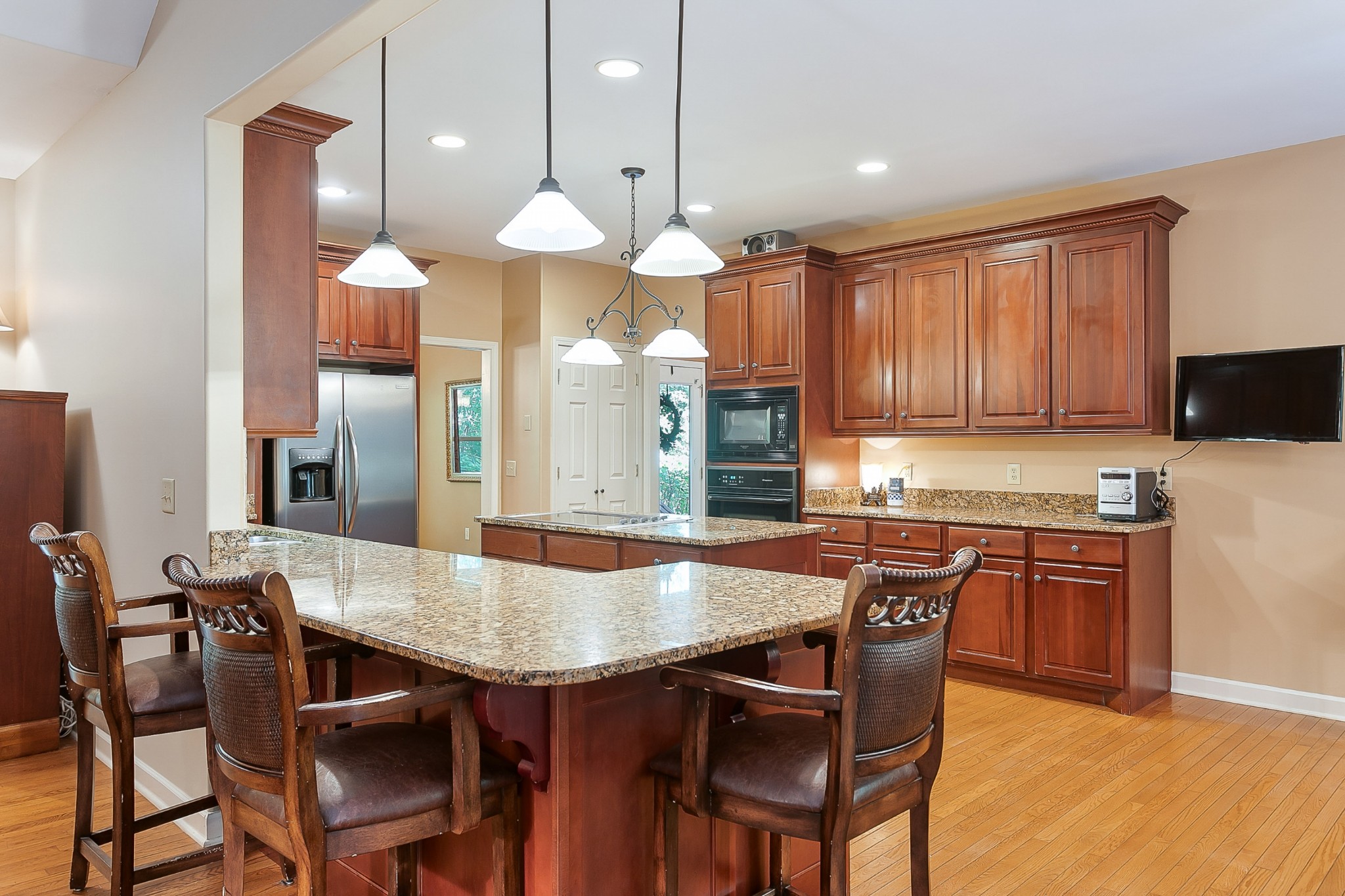 1441 Center Star Road Columbia, TN 38401 - Photo 14 of 62 a kitchen with a dining table chairs stainless steel appliances and cabinets