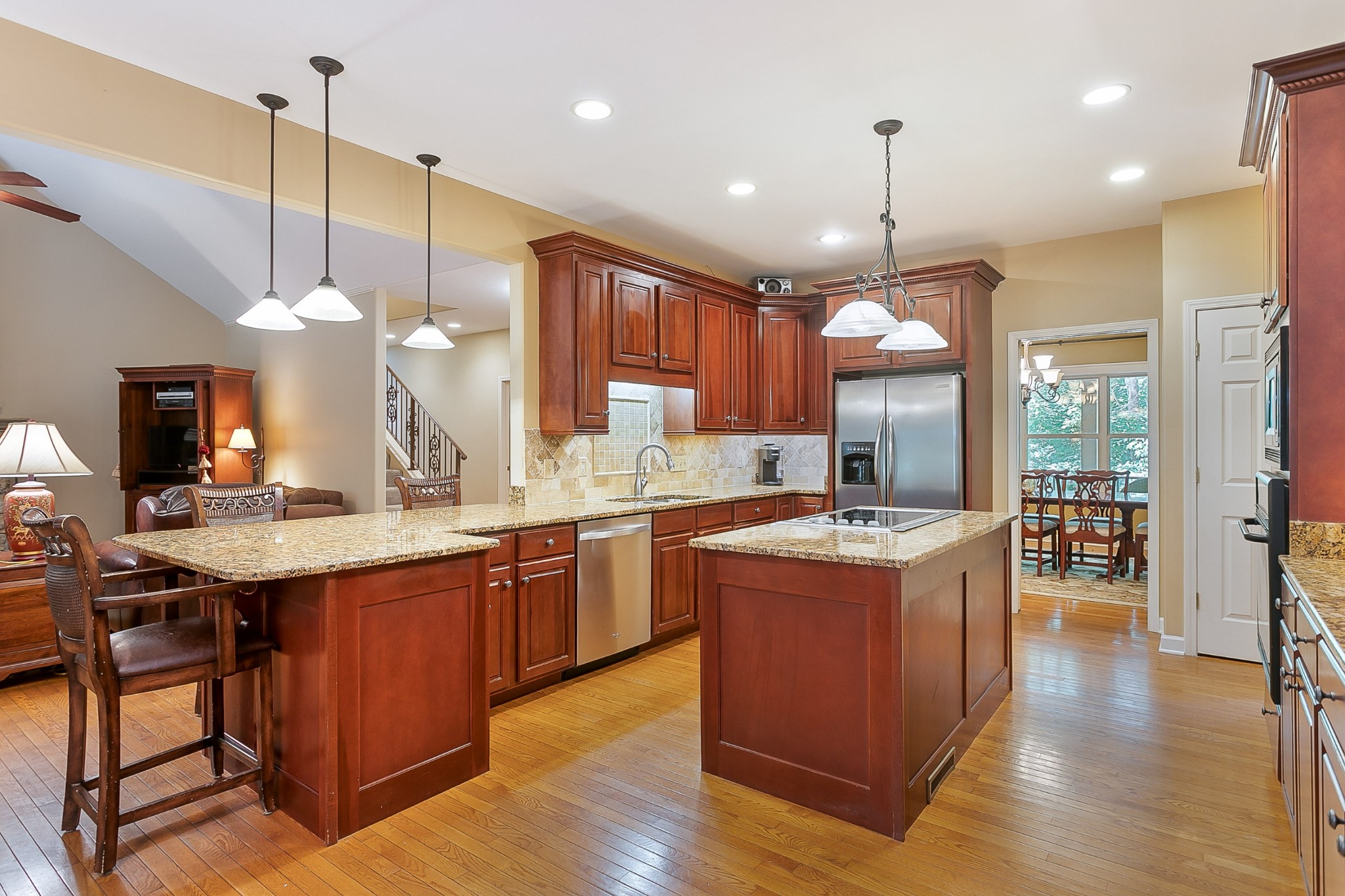1441 Center Star Road Columbia, TN 38401 - Photo 15 of 62 a kitchen with stainless steel appliances granite countertop a stove a sink a center island a sink and a wooden floor