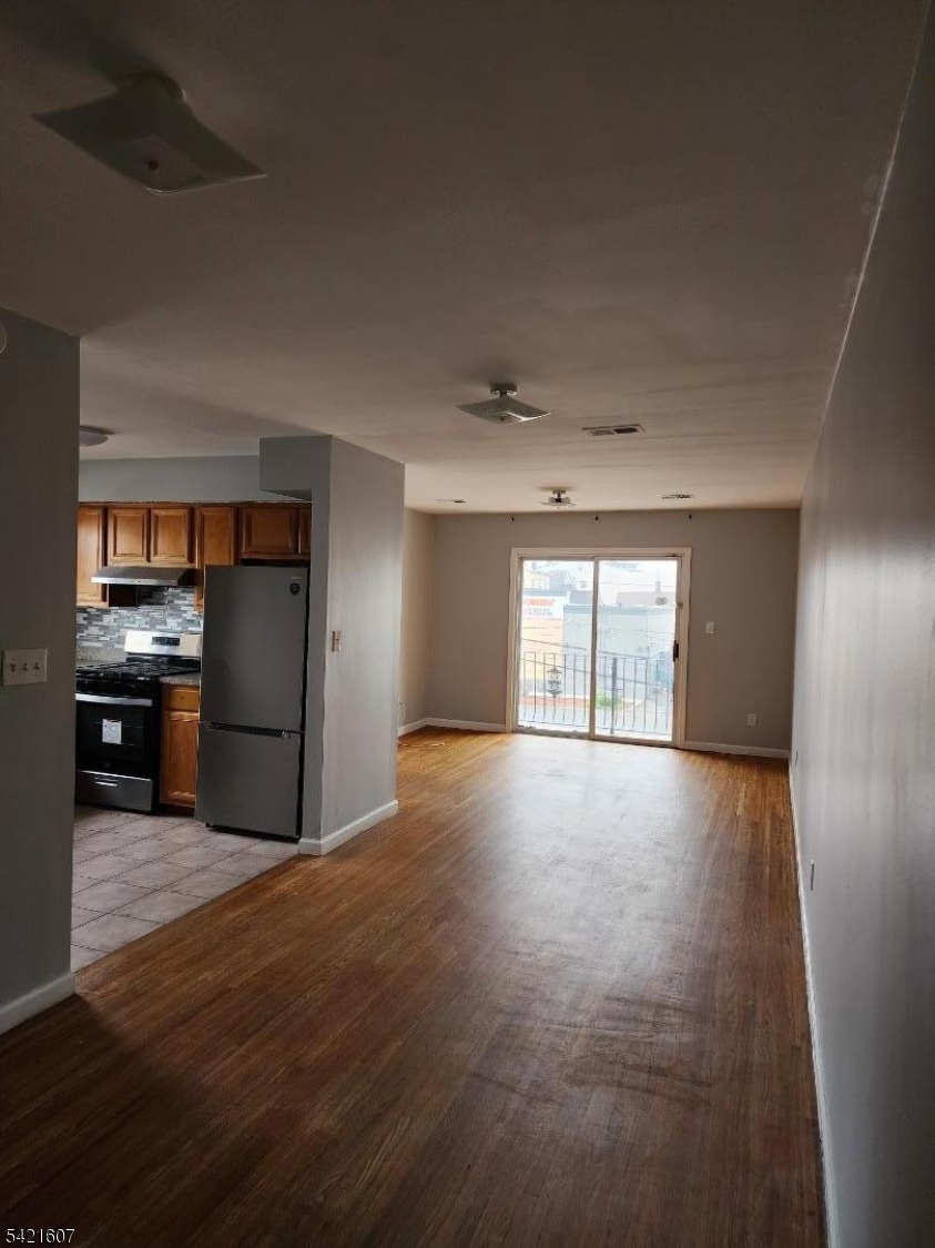 16 5th Street, Unit 2 Elizabeth Port, NJ 07206 - Photo 3 of 14 a view of a kitchen with a sink and a refrigerator