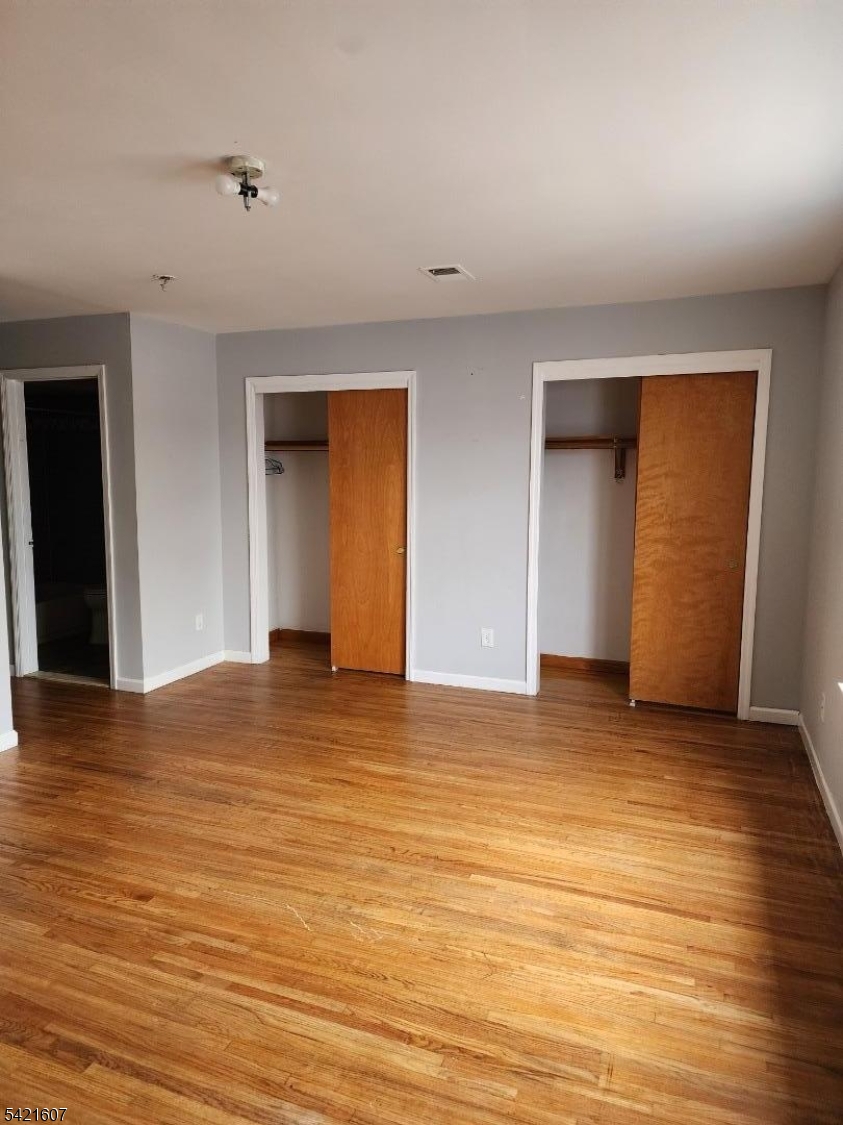 16 5th Street, Unit 2 Elizabeth Port, NJ 07206 - Photo 4 of 14 a view of empty room with wooden floor