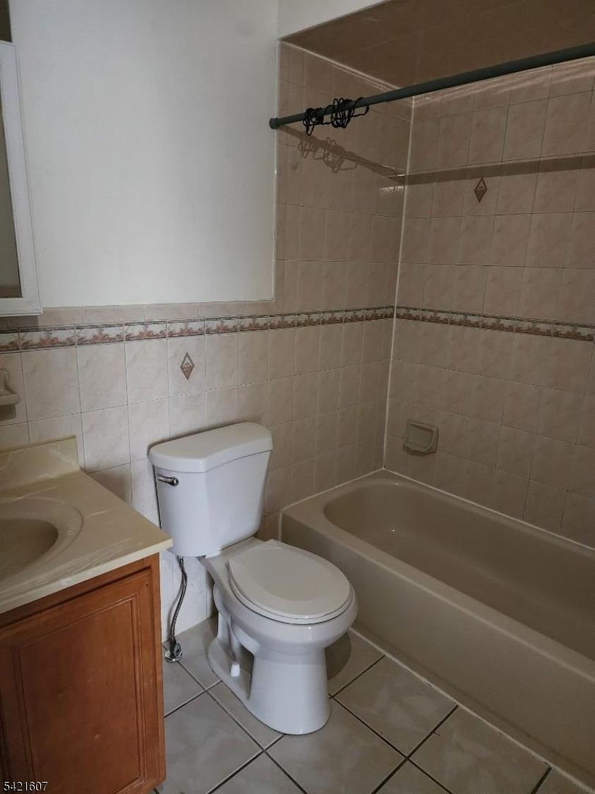16 5th Street, Unit 2 Elizabeth Port, NJ 07206 - Photo 5 of 14 a white toilet sitting next to a bath tub