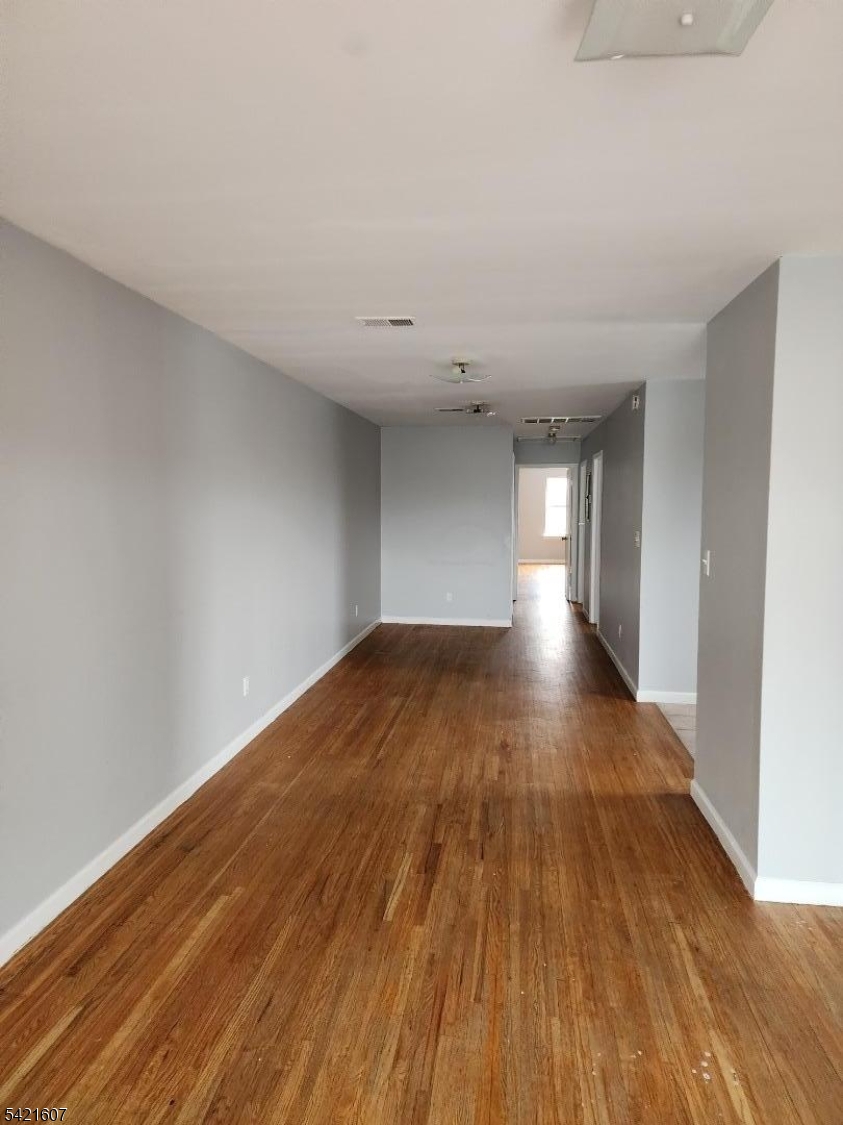 16 5th Street, Unit 2 Elizabeth Port, NJ 07206 - Photo 10 of 14 a view of empty room with wooden floor