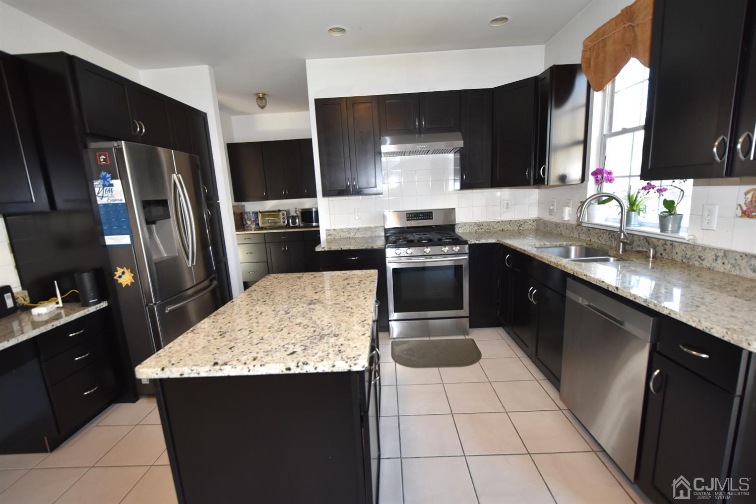 23 Timber Ridge Road North Brunswick, NJ 08902 - Photo 9 of 28 a kitchen with stainless steel appliances granite countertop a sink stove and refrigerator