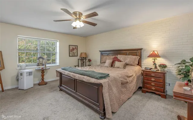 a bedroom with a bed and a table chair