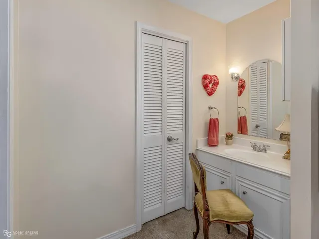 a bathroom with a sink vanity and a mirror